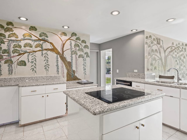 922 S School St, Mount Prospect, IL 60056 - kitchen with black appliances, recessed lighting, white cabinetry, a center island, and light tile patterned flooring
