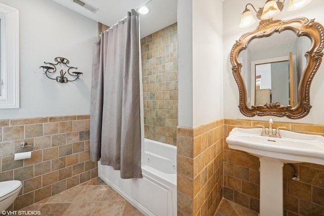 32W634 Oak Lawn Farm Rd, Wayne, IL 60184 - bathroom featuring tile walls, a combined bath / shower with jetted tub, wainscoting, and tile patterned floors