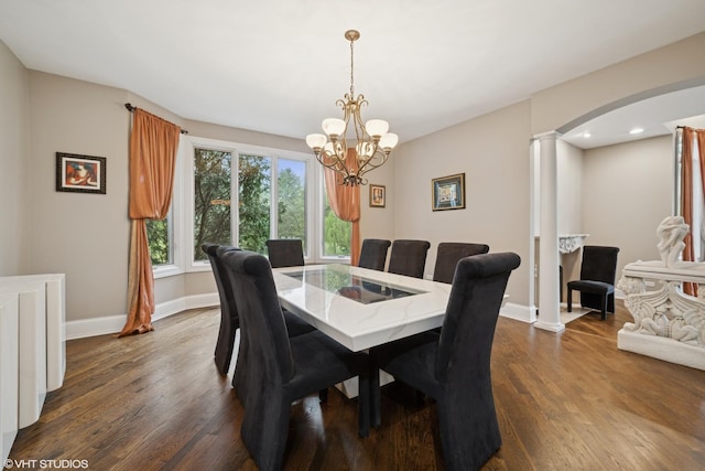 32W634 Oak Lawn Farm Rd, Wayne, IL 60184 - dining area featuring ornate columns, dark wood-style flooring, arched walkways, and a chandelier