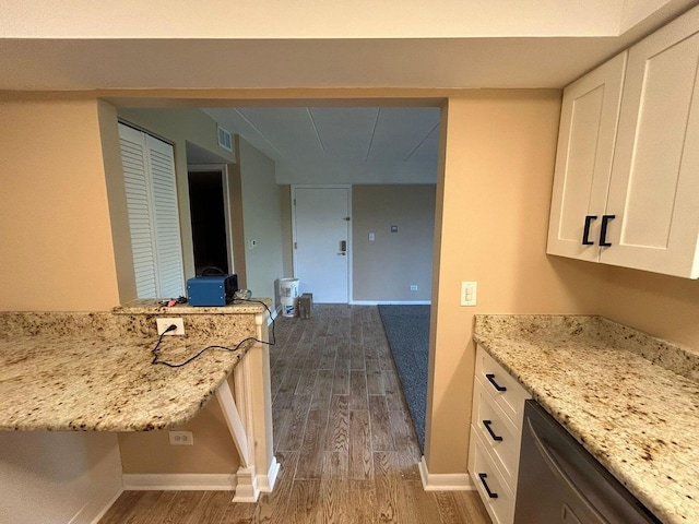 15137 Quail Hollow Dr Unit 203, Orland Park, IL 60462 - kitchen with dark wood-type flooring, white cabinets, stainless steel dishwasher, and light stone countertops