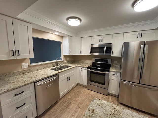 15137 Quail Hollow Dr Unit 203, Orland Park, IL 60462 - kitchen with stainless steel appliances, crown molding, light wood finished floors, white cabinets, and light stone countertops