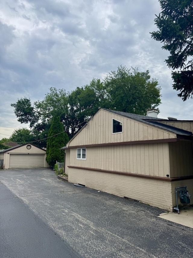 5125 W 101st St, Oak Lawn, IL 60453 - view of property exterior featuring brick siding, a garage, and an outbuilding