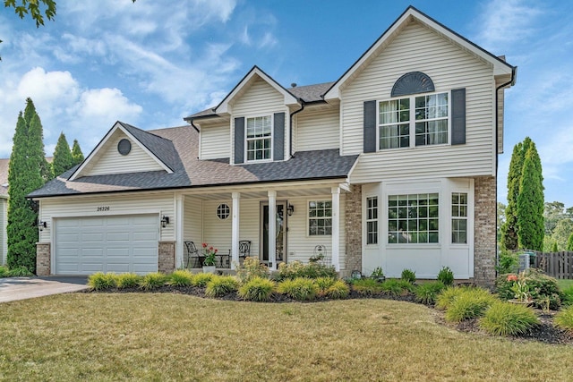 26226 W Tallgrass Trl, Channahon, IL 60410 - traditional-style home featuring covered porch, an attached garage, driveway, and a front yard