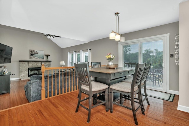 26226 W Tallgrass Trl, Channahon, IL 60410 - dining area with wood finished floors, ceiling fan, a brick fireplace, and lofted ceiling