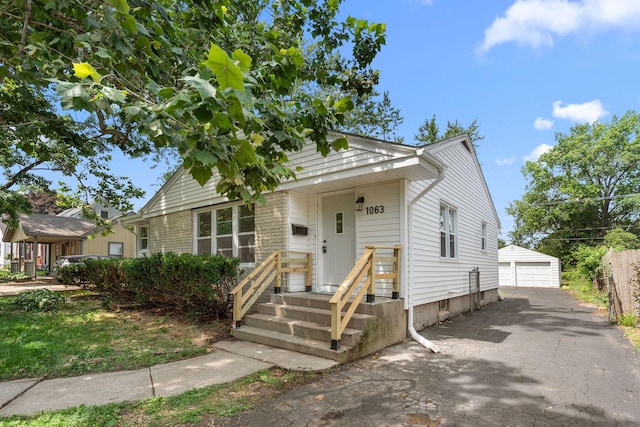 1063 S 8th Ave, Kankakee, IL 60901 - view of front of home with a detached garage and an outdoor structure