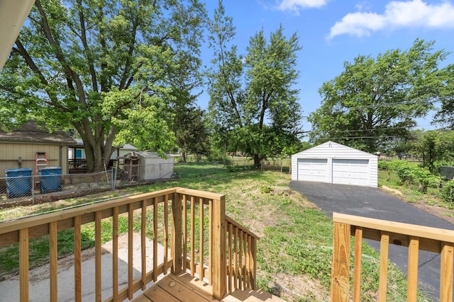 1063 S 8th Ave, Kankakee, IL 60901 - wooden deck featuring a detached garage and an outdoor structure