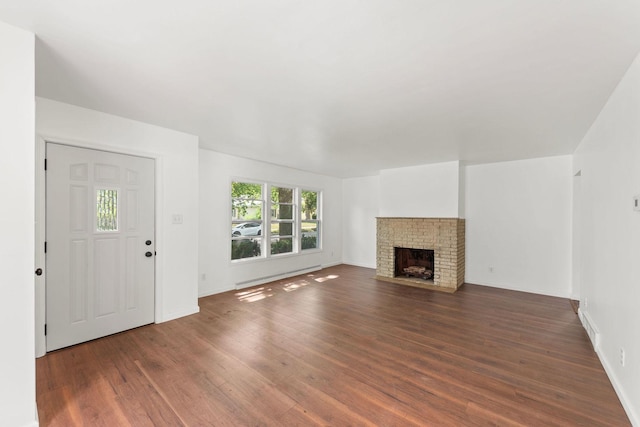 1063 S 8th Ave, Kankakee, IL 60901 - unfurnished living room featuring wood finished floors and a brick fireplace
