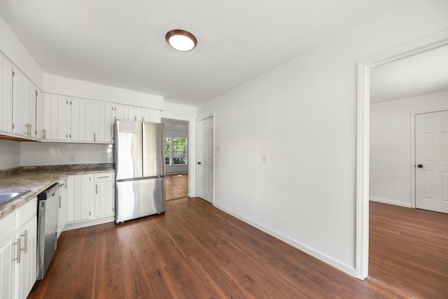 1063 S 8th Ave, Kankakee, IL 60901 - kitchen with appliances with stainless steel finishes, dark wood-style floors, white cabinets, and tasteful backsplash