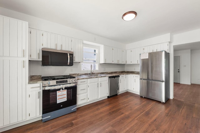 1063 S 8th Ave, Kankakee, IL 60901 - kitchen featuring stainless steel appliances, dark wood finished floors, white cabinets, and tasteful backsplash