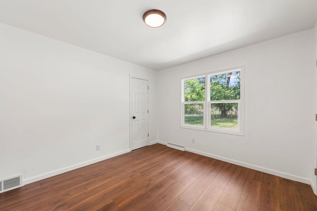 1063 S 8th Ave, Kankakee, IL 60901 - empty room featuring baseboards and dark wood-style flooring