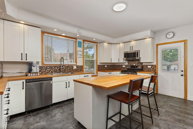 2800 Auxplaines Ave, River Grove, IL 60171 - kitchen featuring wooden counters, appliances with stainless steel finishes, a breakfast bar area, white cabinetry, and recessed lighting