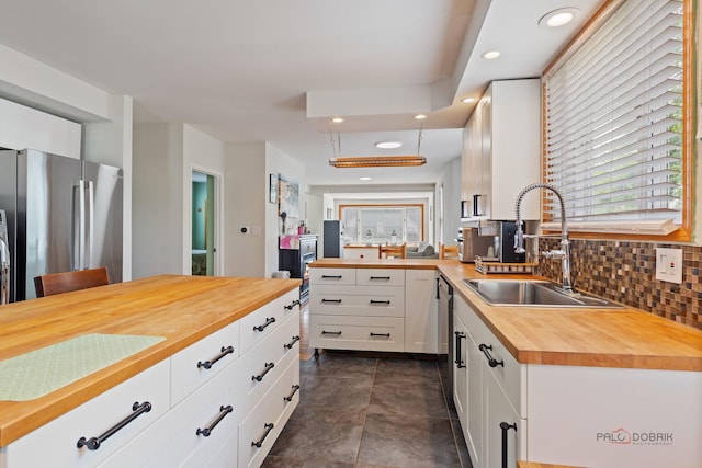 2800 Auxplaines Ave, River Grove, IL 60171 - kitchen featuring butcher block countertops, freestanding refrigerator, recessed lighting, white cabinets, and decorative backsplash