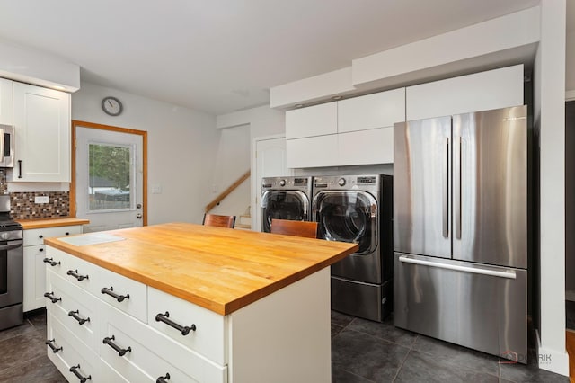 2800 Auxplaines Ave, River Grove, IL 60171 - kitchen featuring appliances with stainless steel finishes, butcher block counters, independent washer and dryer, backsplash, and white cabinets