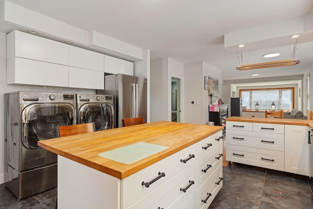 2800 Auxplaines Ave, River Grove, IL 60171 - kitchen with wooden counters, washer and clothes dryer, freestanding refrigerator, white cabinetry, and a kitchen island