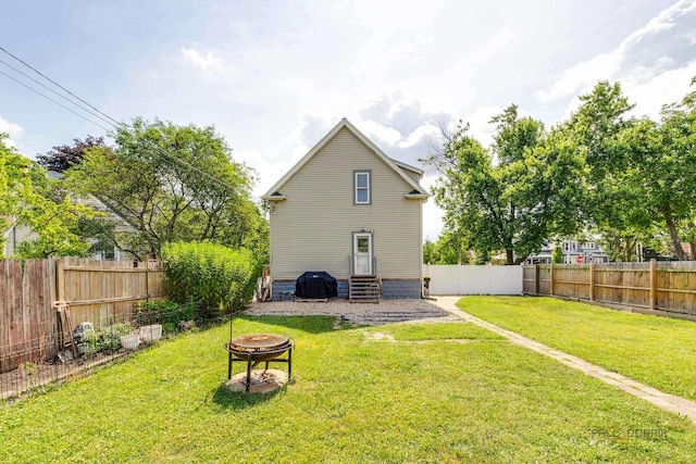 2800 Auxplaines Ave, River Grove, IL 60171 - rear view of house with a fire pit, entry steps, and a fenced backyard