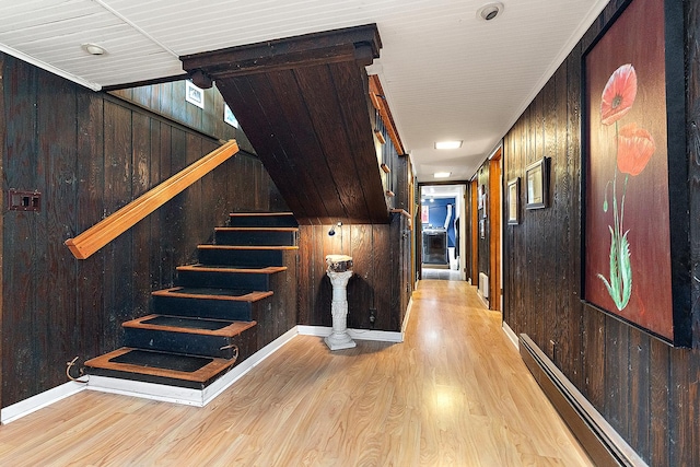1108 Plaza Dr, New Lenox, IL 60451 - hallway featuring a baseboard radiator, light wood finished floors, wooden walls, and stairs