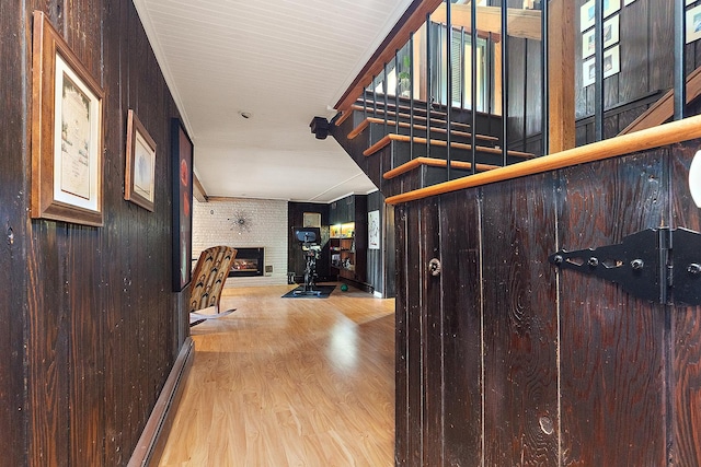 1108 Plaza Dr, New Lenox, IL 60451 - corridor featuring baseboard heating, wood finished floors, stairs, and wood walls
