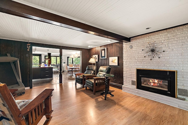 1108 Plaza Dr, New Lenox, IL 60451 - living area featuring beam ceiling, wood finished floors, a brick fireplace, and wooden walls