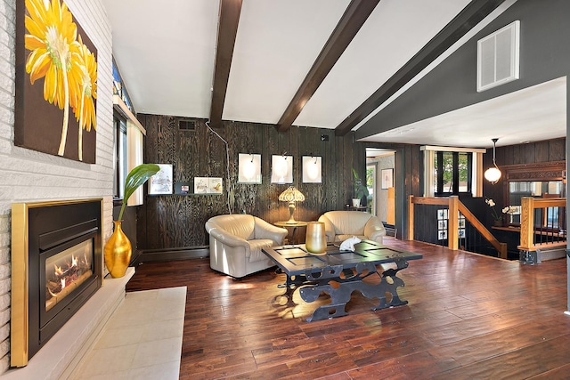 1108 Plaza Dr, New Lenox, IL 60451 - living area with wood walls, a glass covered fireplace, hardwood / wood-style flooring, and beamed ceiling
