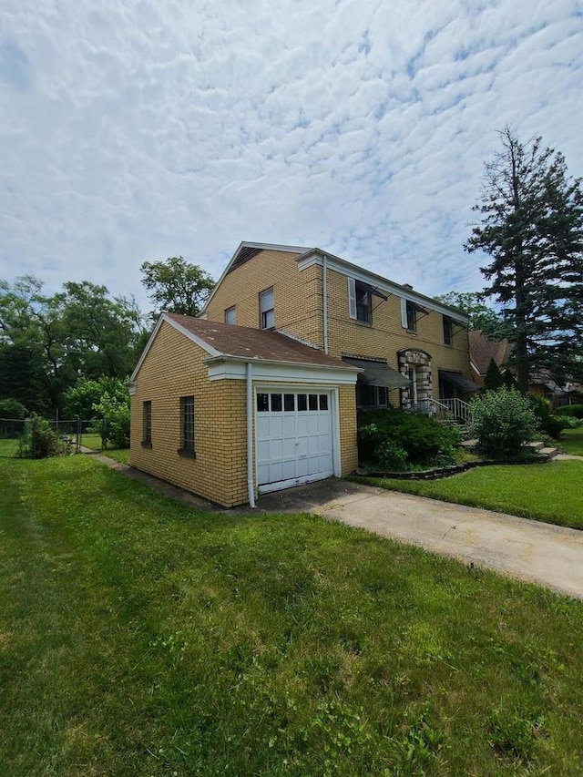 view of front of house with concrete driveway, a front yard, brick siding, and an attached garage