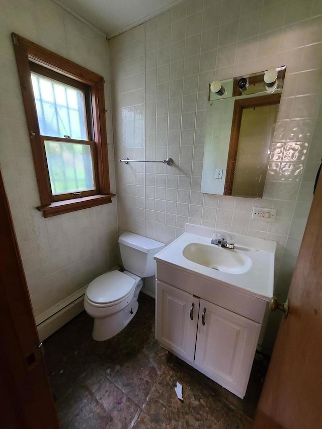 half bathroom with tile walls, vanity, a baseboard heating unit, and decorative backsplash