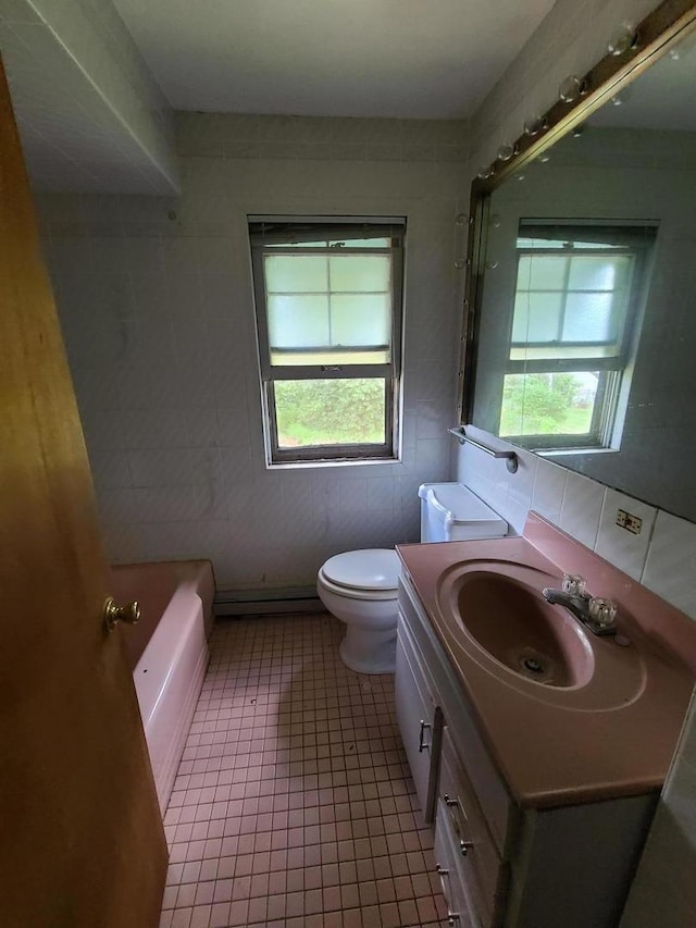 bathroom featuring vanity, tile patterned flooring, and a bathtub