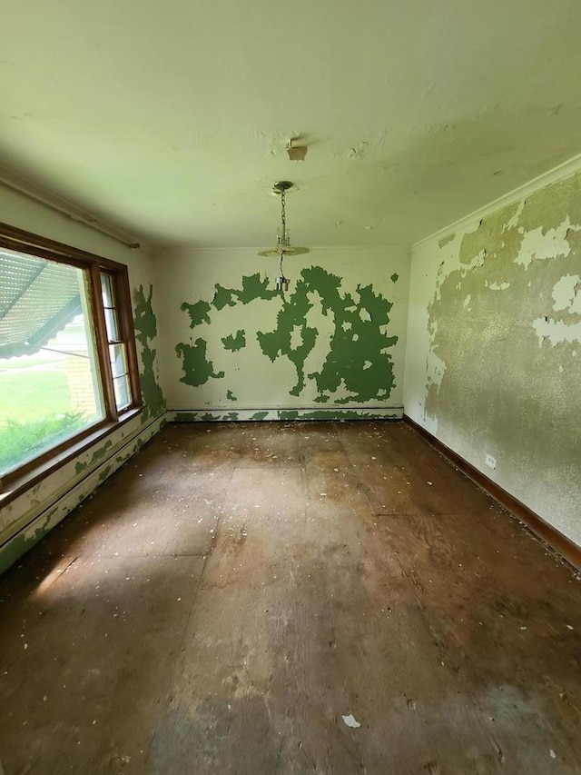 unfurnished room featuring baseboards
