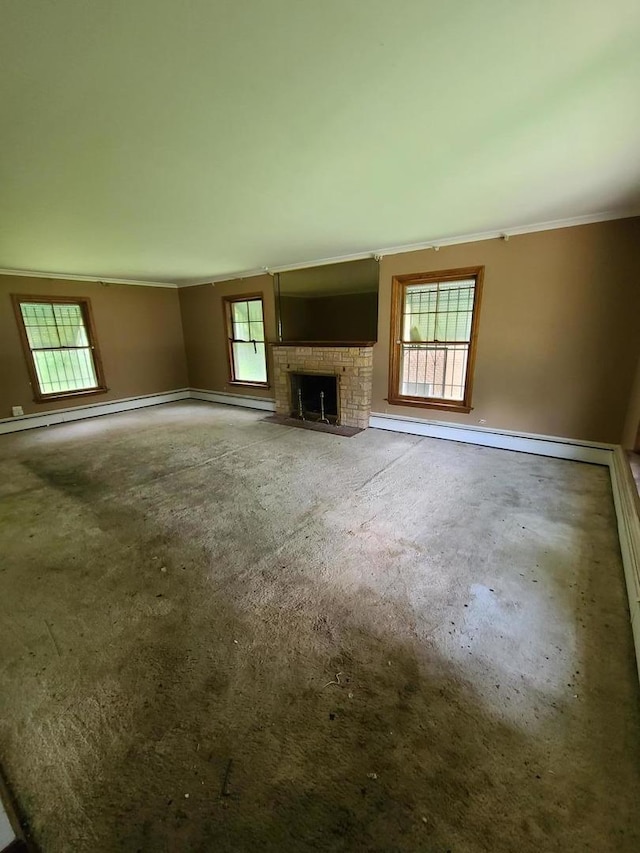 unfurnished living room with ornamental molding, carpet flooring, a fireplace, and a baseboard radiator