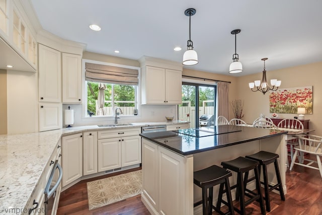 285 N Bay Ct, Lake Barrington, IL 60010 - kitchen featuring dark wood finished floors, black electric cooktop, a kitchen breakfast bar, a center island, and a chandelier