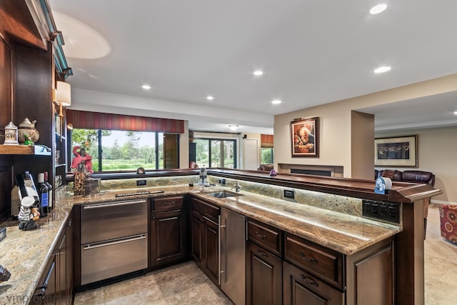 285 N Bay Ct, Lake Barrington, IL 60010 - kitchen with recessed lighting, dark brown cabinetry, stone finish floors, light stone counters, and open floor plan