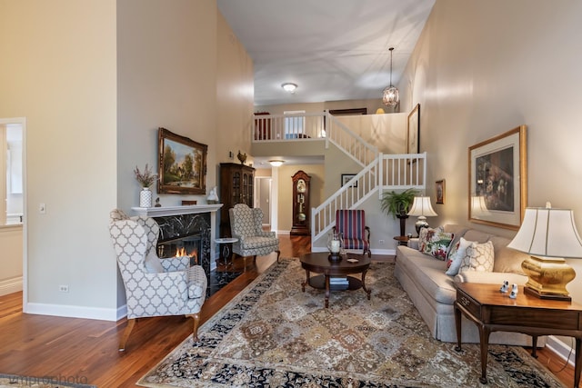 285 N Bay Ct, Lake Barrington, IL 60010 - living room featuring wood finished floors, a high ceiling, a premium fireplace, and stairway