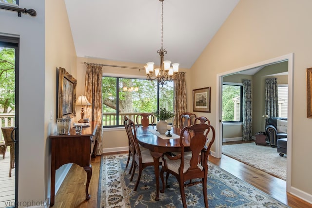285 N Bay Ct, Lake Barrington, IL 60010 - dining area with wood finished floors, a chandelier, healthy amount of natural light, and high vaulted ceiling