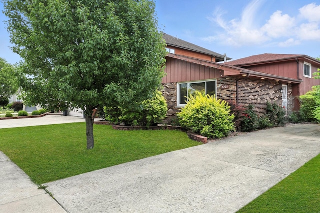 5721 W 88th Pl, Oak Lawn, IL 60453 - view of front of property featuring driveway, brick siding, a front yard, a shingled roof, and a garage
