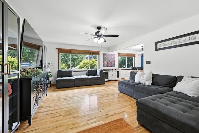 5721 W 88th Pl, Oak Lawn, IL 60453 - living area featuring a chandelier, a ceiling fan, and light wood finished floors