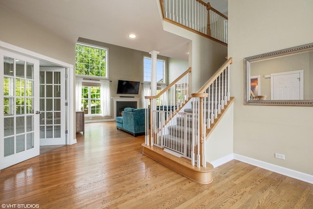 1755 Goldsboro Ln, Crystal Lake, IL 60014 - staircase with wood finished floors, a high ceiling, a lit fireplace, and recessed lighting