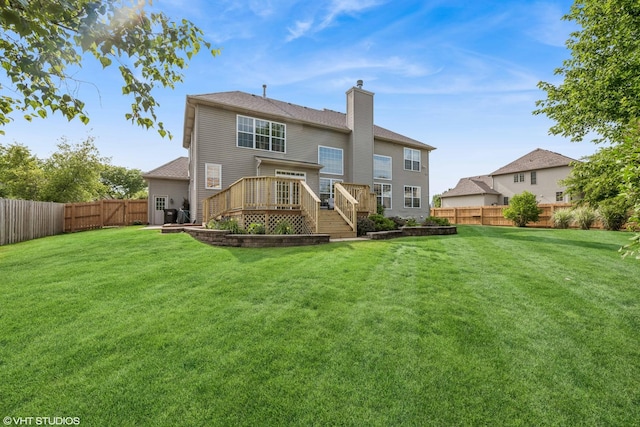 1755 Goldsboro Ln, Crystal Lake, IL 60014 - back of property with a fenced backyard, a chimney, stairway, and a wooden deck