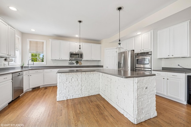 1755 Goldsboro Ln, Crystal Lake, IL 60014 - kitchen featuring appliances with stainless steel finishes, a kitchen island, white cabinets, light wood-style flooring, and recessed lighting