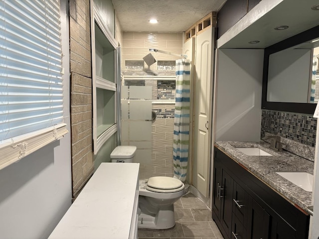 11071 E Fisher Rd, Rochelle, IL 60168 - bathroom with a tile shower, double vanity, tasteful backsplash, and a textured ceiling