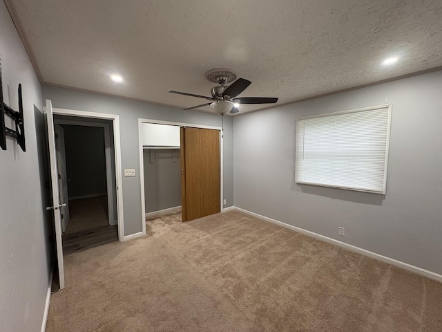 11071 E Fisher Rd, Rochelle, IL 60168 - unfurnished bedroom with a closet, light colored carpet, ceiling fan, a textured ceiling, and recessed lighting