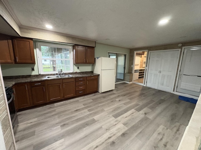 11071 E Fisher Rd, Rochelle, IL 60168 - kitchen with freestanding refrigerator, dark countertops, light wood-type flooring, ornamental molding, and recessed lighting