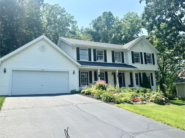 120 Colebrook Pl, Rockton, IL 61072 - view of front facade featuring a porch, concrete driveway, a garage, and a front lawn