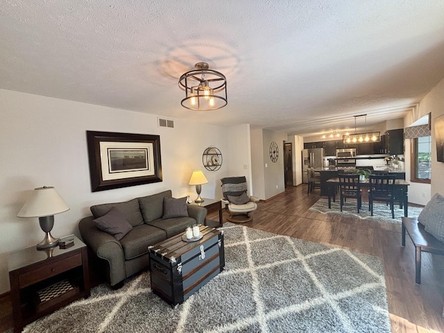 120 Colebrook Pl, Rockton, IL 61072 - living area with a chandelier, wood finished floors, and a textured ceiling