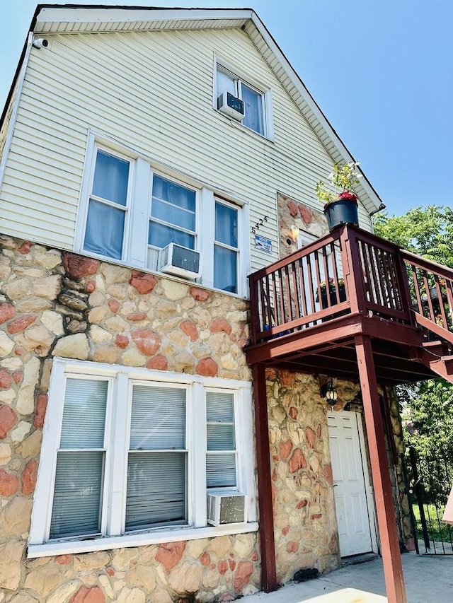 5424 S Winchester Ave, Chicago, IL 60609 - view of property exterior featuring stone siding, cooling unit, a surveillance system, and a balcony