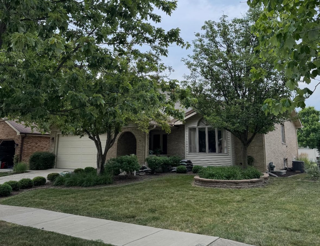 17081 Bonnie Trl W, Oak Forest, IL 60452 - obstructed view of property with a front yard, a garage, concrete driveway, and brick siding
