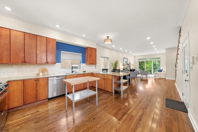 2031 W Saint Paul Ave Unit 2W, Chicago, IL 60647 - kitchen featuring stainless steel appliances, a peninsula, decorative backsplash, wood finished floors, and recessed lighting