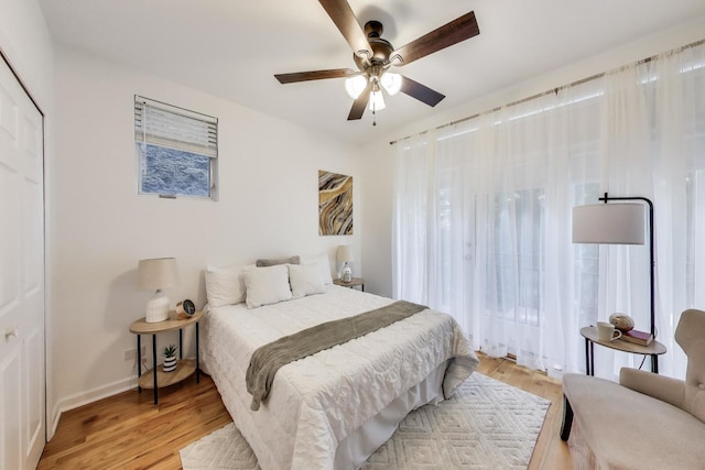 2145 W Crystal St Unit 1, Chicago, IL 60622 - bedroom with light wood-type flooring, multiple windows, and a ceiling fan