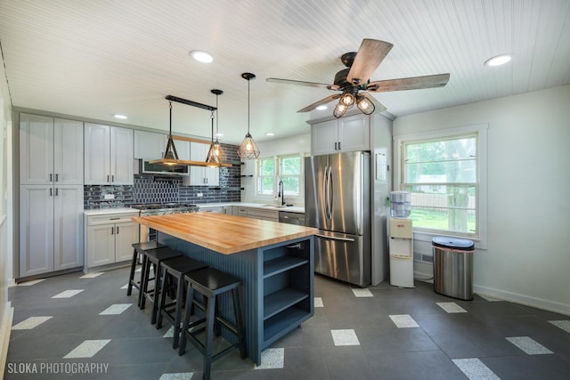 531 Rockland Rd, Crystal Lake, IL 60014 - kitchen featuring butcher block countertops, appliances with stainless steel finishes, open shelves, a kitchen breakfast bar, and a ceiling fan