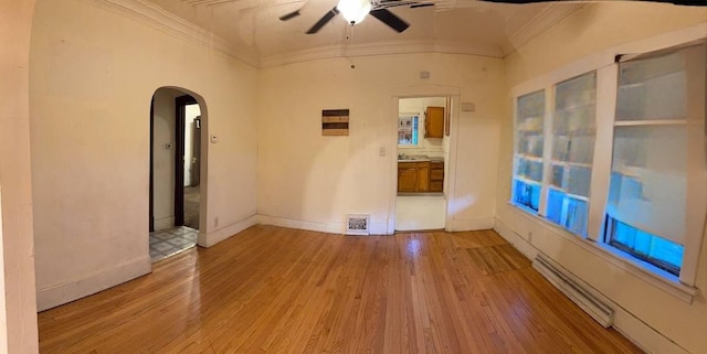 15121 Vine Ave, Harvey, IL 60426 - unfurnished room with crown molding, ceiling fan, arched walkways, wood finished floors, and a baseboard heating unit