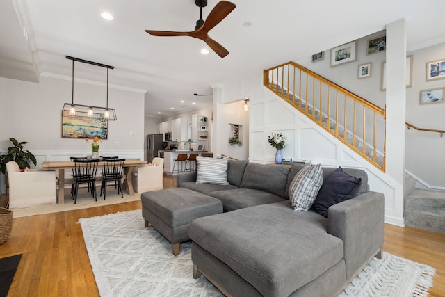 3316 N Leavitt St Unit 2, Chicago, IL 60618 - living room featuring stairs, ceiling fan, a decorative wall, light wood-style flooring, and ornamental molding
