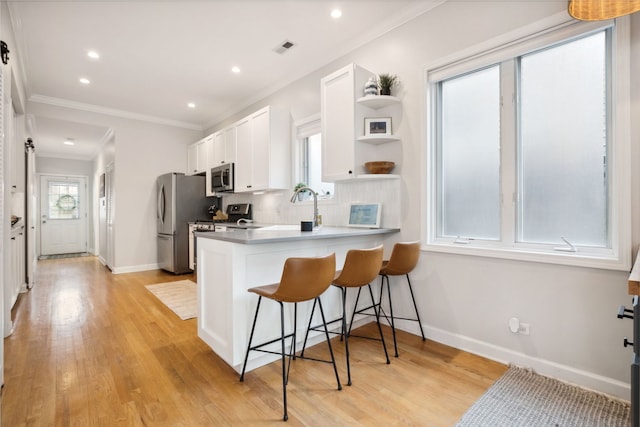 3316 N Leavitt St Unit 2, Chicago, IL 60618 - kitchen featuring stainless steel appliances, a kitchen bar, white cabinets, open shelves, and light wood-style floors